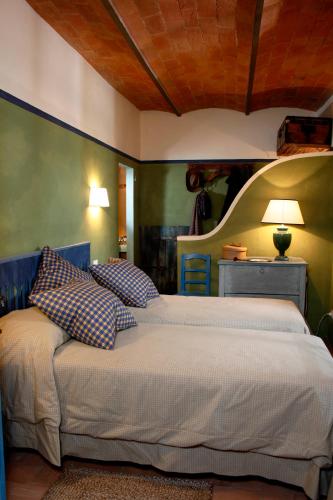 a bedroom with a bed with pillows on it at I Veroni - Agriturismo and Wine Cellar in Pontassieve