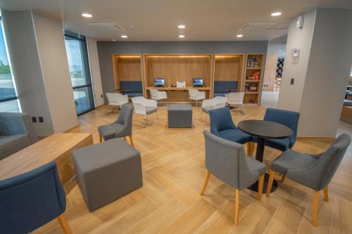 a waiting room with chairs and a table and a desk at Highland Chihuahua in Chihuahua