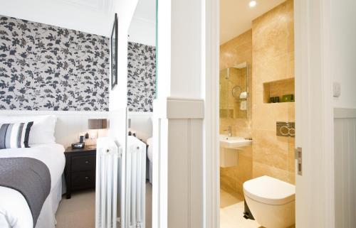 a bedroom with a bed and a toilet and a bathroom at 27 The Terrace in St Ives