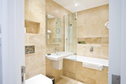 a bathroom with a sink and a mirror at 27 The Terrace in St Ives