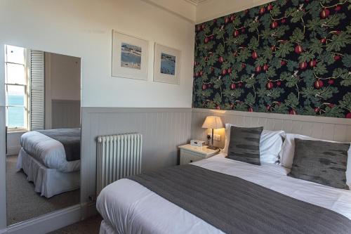 a hotel room with two beds and a christmas wall at 27 The Terrace in St Ives