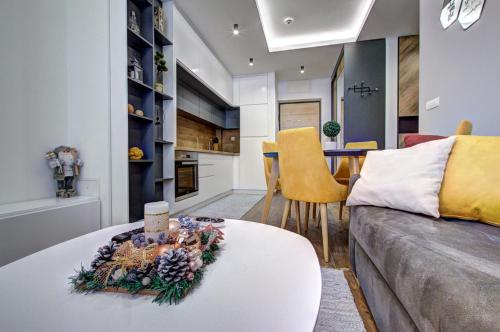 a living room with a couch and a table at Apartment A1 Lux Alpin in Jahorina