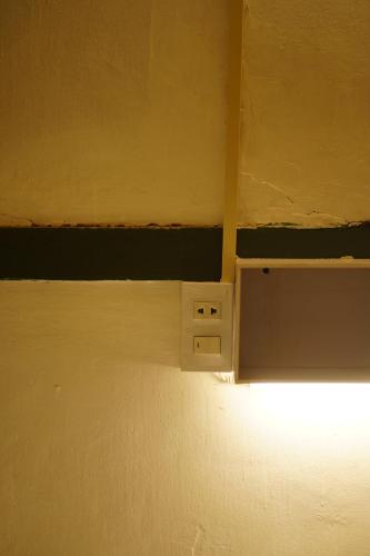 a ceiling with a light in a room at Barn Laos Hostel in Vientiane