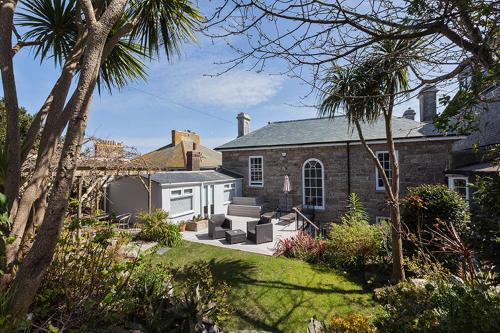 a brick house with a patio in the yard at 27 The Terrace in St Ives