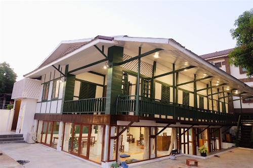a large building with a lot of windows at Barn Laos Hostel in Vientiane