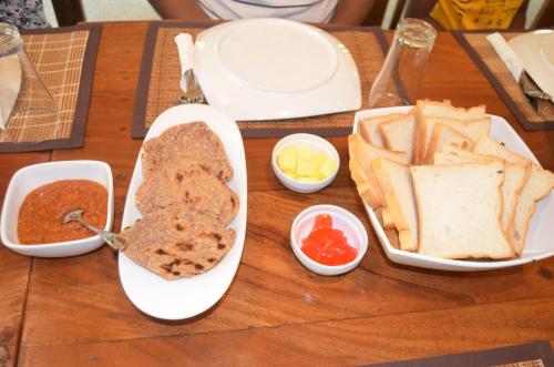 a table with two plates of bread and dips at Agro Village Resort , Kalpitiya in Kalpitiya