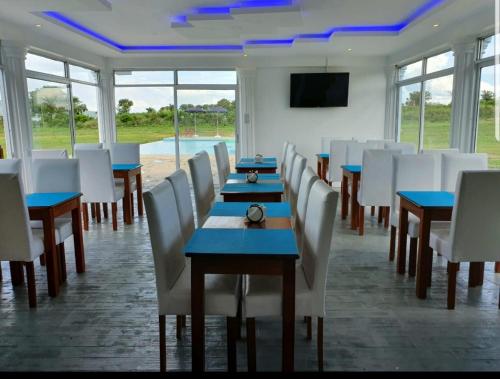 a conference room with tables and chairs and a tv at VICTORIA SANDS LODGE in Mbita