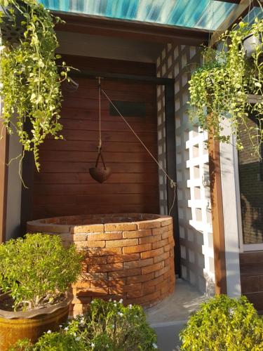 a front porch of a house with a brick wall at Mon-Dee minihotel in Nan