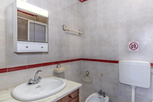 a bathroom with a sink and a toilet at FLH Altura Beach Apartment in Altura