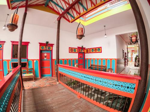 a colorful restaurant with a red and blue railing at Hotel Jardin Antioquia in Jardin