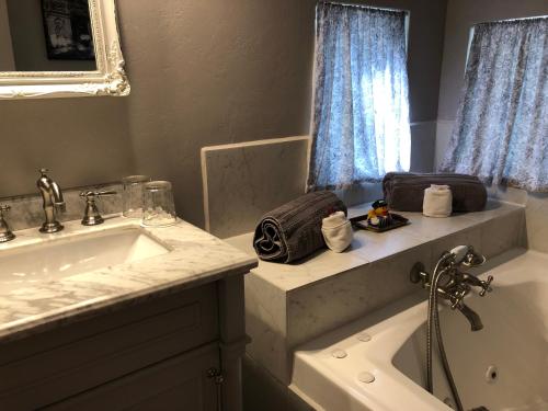 a bathroom with a tub and a sink and a bath tub at Featherbed Railroad in Upper Lake