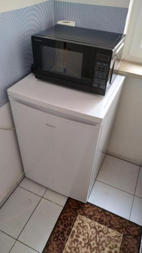 a microwave sitting on top of a white refrigerator at Budget Friendly Private Apartment in Sindelfingen