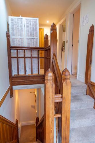 a wooden staircase with wooden railings in a house at Apartment No.2 - The Old Red King Pub MCR in Manchester