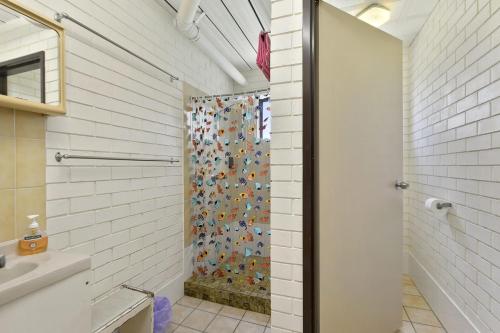 a bathroom with a shower with a glass door at Angabunga in Point Lookout