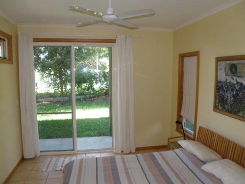 una camera da letto con un letto e una grande finestra di 11 Bambara Street a Point Lookout