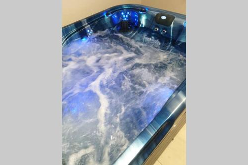 a bath tub filled with water with clouds at AU BONHEUR DE PINPIN in Les Abymes