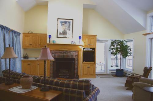 a living room with a couch and a fireplace at Maple Hill Farm Bed & Breakfast in New London