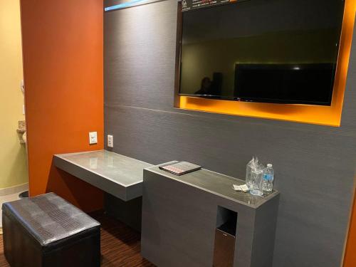 a bathroom with a sink and a mirror and a stool at Hotel Lua in Mexico City