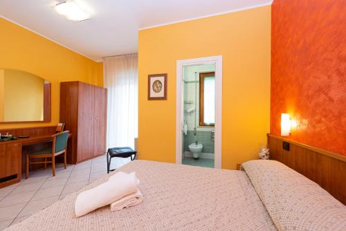 a hotel room with a bed and a bathroom at La Lanterna in Silvi Marina