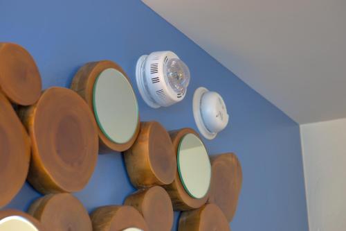 a pile of wooden plates on a wall with a light at Paradise Point Resort & Spa in San Diego