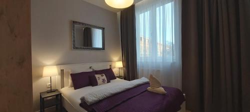 a hotel room with a bed and a window at Central Apartments Rajska in Gdańsk