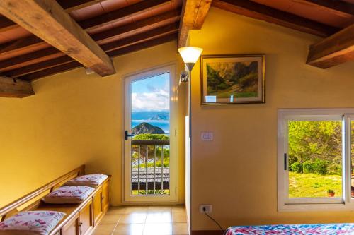 a bedroom with two beds and a window at Villa Glaucos in Capoliveri