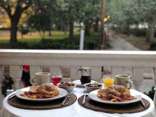 a table with two plates of food and drinks at Forsyth Park Inn in Savannah