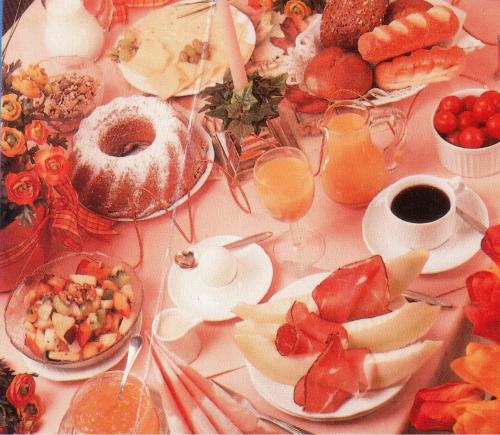 a table topped with plates of food and glasses of orange juice at Central Hotel in Worms