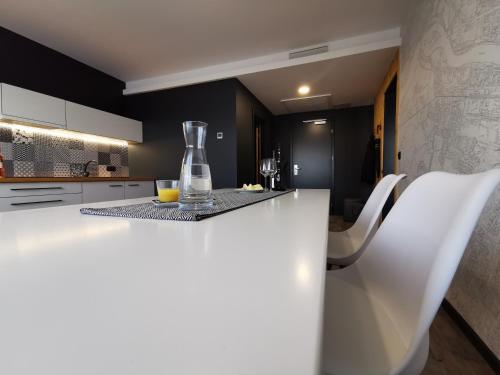 a kitchen with a white counter with a vase on it at Hotel CityMap Maribor in Maribor