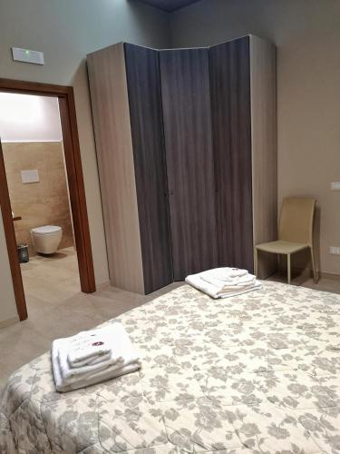 a bedroom with a bed with towels on it at Agriturismo La Fattoria B&B in Limatola
