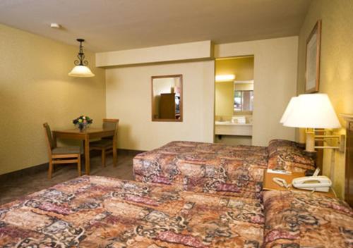 a hotel room with two beds and a table with a telephone at Arizona Charlie's Boulder in Las Vegas