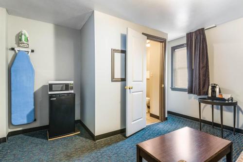 a hotel room with a door and a table and a room at Cottage Inn - Grantville in Grantville