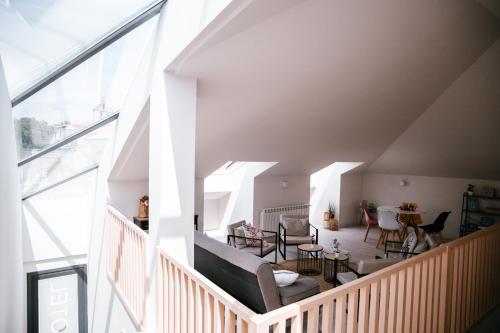 a room with a staircase with chairs and a table at O balcón da ribeira in Parada del Sil