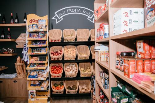 a grocery store filled with lots of baskets of food at O balcón da ribeira in Parada del Sil