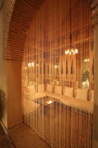 a room filled with white chairs and a large wall of mirrors at Les Deux Tours in Marrakech