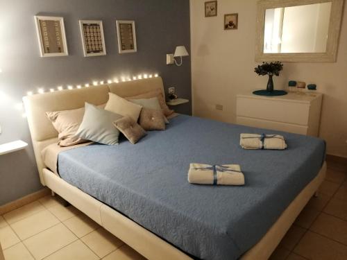 a bedroom with a large bed with two towels on it at Quattro Canti Valù in Palermo