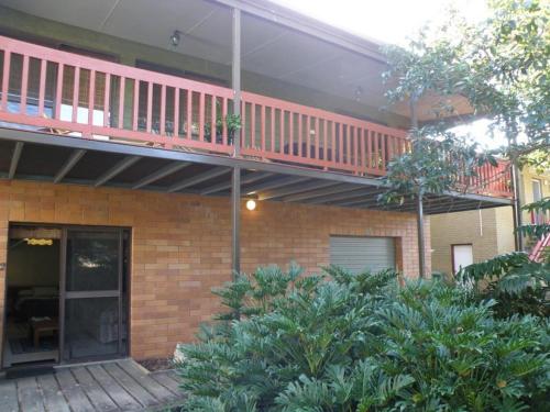 a brick house with a balcony on top of it at Haven in Point Lookout