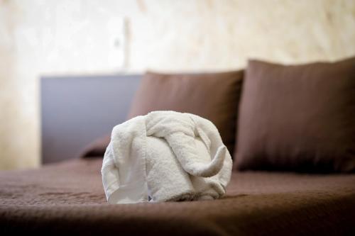 a white towel is sitting on a bed at Hostal Conde David in Salamanca