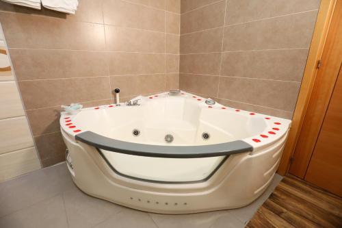a bathroom with a bath tub in a room at Hostal Conde David in Salamanca