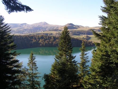 a view of crater lake through the trees at Gergovia in Super Besse