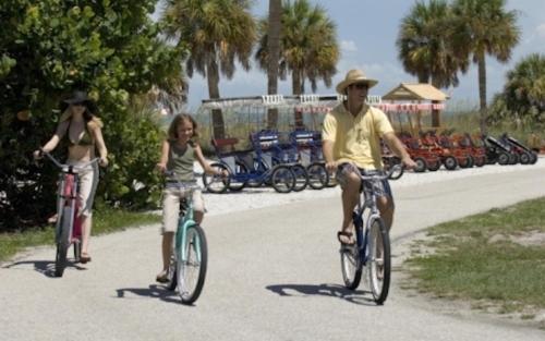 a couple of people riding bikes down a road at TWO Bedroom TWO Bath Family Condo - Sleeps Four - Unit B - Private Beach in St. Petersburg