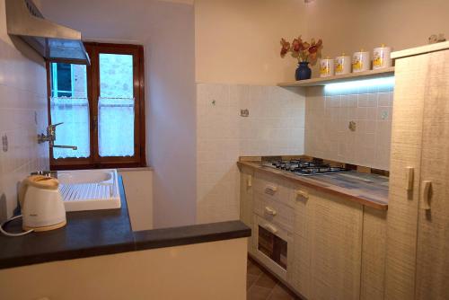 a kitchen with a sink and a counter top at Casa vacanze Da Anastasia in Orvieto