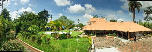 a building with an orange roof in a park at Cotinga Hotel Spa in Pereira