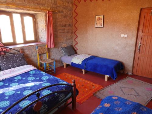 Una cama o camas en una habitación de Auberge Hostel Traditionnel
