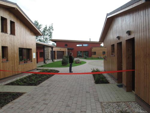 a person is standing in a hallway between two buildings at Ranč Orlice in Třebechovice pod Orebem