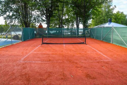a tennis court with a net on top of it at Ursand Resort & Camping in Vänersborg
