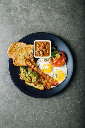 a plate of breakfast food with eggs sausage and toast at Merrill House in Picton