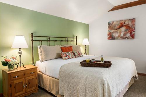 a bedroom with a large bed with a basket on it at The La Conner Inn in La Conner
