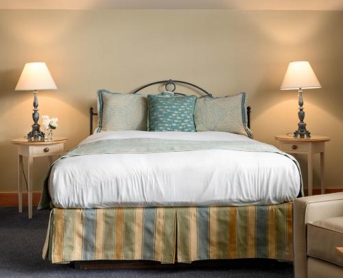 a bedroom with a bed with pillows and two lamps at La Conner Channel Lodge in La Conner