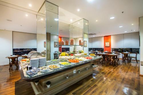 a buffet in a hotel with a lot of food at JR Hotel Ribeirão Preto in Ribeirão Preto